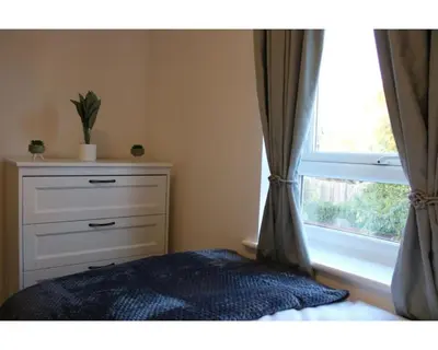 a bedroom with a dresser and a window at A Comfortable Nest for Contractors or Families - sleeps 8 in Chesterton