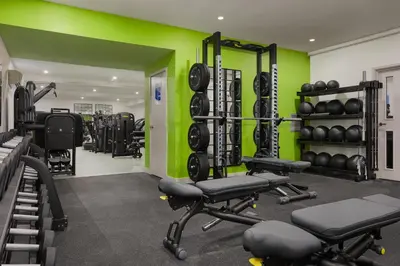 a gym with dumbbells and weights at Ufford Park Resort in Woodbridge