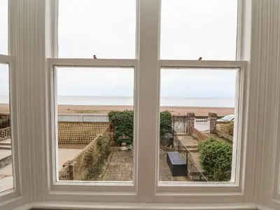 an open window with a view of the beach at 42 Crag Path in Aldeburgh