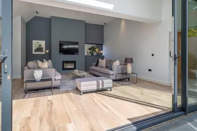 a living room with two couches and a fireplace at Court House, Aldeburgh in Aldeburgh