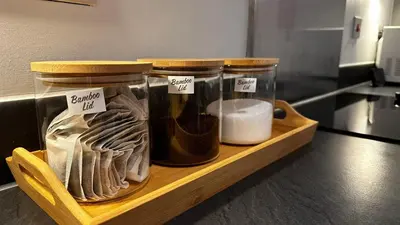 a wooden shelf with two glass jars filled with food at Long Stay - Free Parking - Contractors - Train Station - Students in Colchester