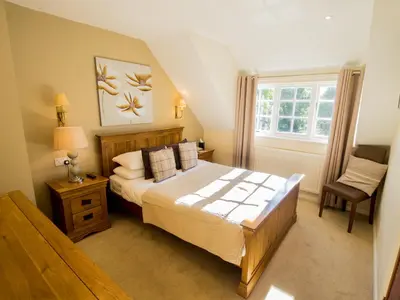 a bedroom with a large bed and a window at Sheene Mill in Melbourn