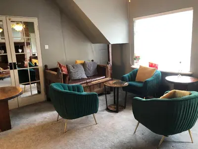 a living room with couches and tables and chairs at Sheene Mill in Melbourn