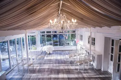 a dining room with a chandelier and a table and chairs at Sheene Mill in Melbourn