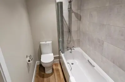 a bathroom with a toilet and a bath tub at Meadow View Lodges in Bury Saint Edmunds