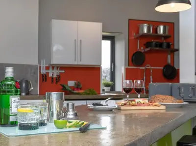 a kitchen with a counter with glasses of wine at 9 Bed in Ipswich oc-62352 in Freston