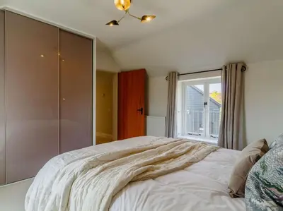 a bedroom with a bed and a window at 3 Bed in Saxmundham oc-89691 in Aldringham