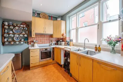 a kitchen with wooden cabinets and a sink at 29 Wentworth Road, Aldeburgh in Aldeburgh