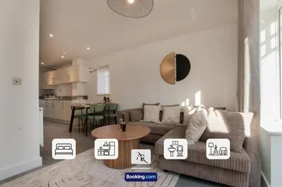 a living room with a couch and a table at 2 Bedroom House By AR Properties Short Lets & Serviced Accommodation Colchester with Garden in Colchester