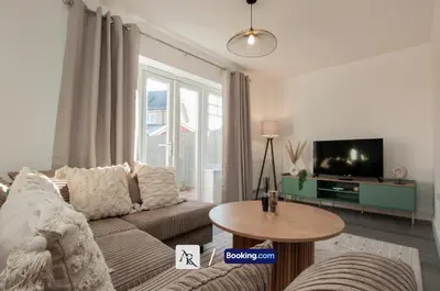 a living room with a couch and a tv at 2 Bedroom House By AR Properties Short Lets & Serviced Accommodation Colchester with Garden in Colchester