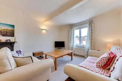 a living room with two couches and a table at 3 Bed in Woodbridge oc-tst in Melton