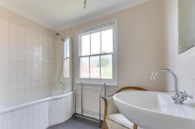 a white bathroom with a tub and a sink at 3 Bed in Woodbridge oc-tst in Melton