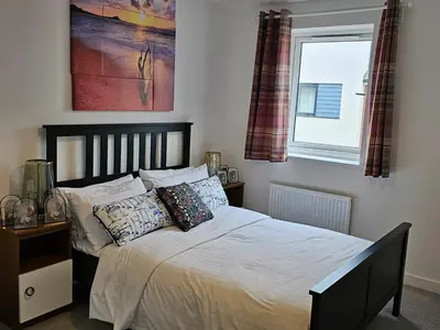 a bedroom with a bed with pillows and a window at Ipswich - 3 Beds - Sleeps 6 - Private Garden in Ipswich