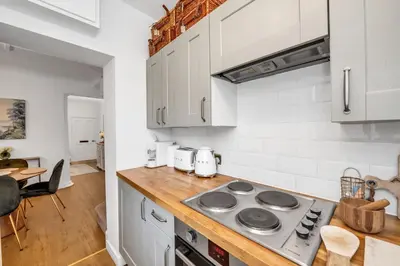 a kitchen with white cabinets and a stove top oven at Charming Church Walk, Long Melford - 2 bedroom property with parking in Long Melford