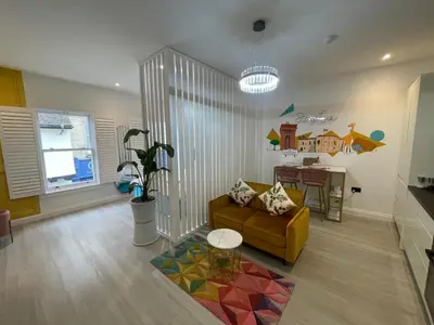 a living room with a couch and a table at Stylish Studio in Colchester