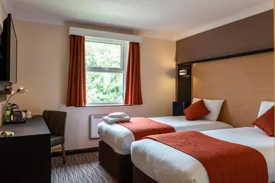 a hotel room with two beds and a window at Dragonfly Hotel Bury St Edmunds in Bury Saint Edmunds