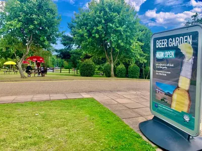 a sign that says beer garden with a bottle of beer at Dragonfly Hotel Bury St Edmunds in Bury Saint Edmunds