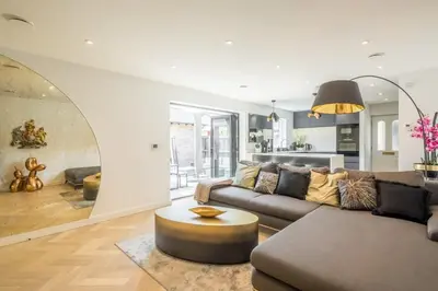 a living room with a couch and a table at Luxury 2 Bedroom Apartment with AC and Parking in Cambridge