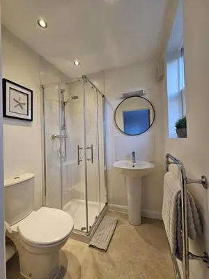 a bathroom with a shower and a toilet and a sink at Eaglegate in Colchester