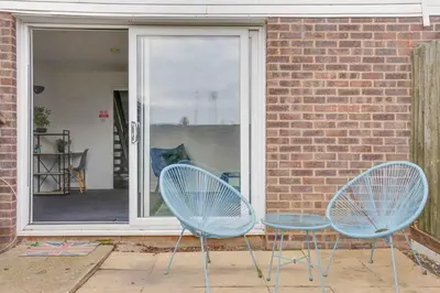 two blue chairs sitting in front of a window at Blackwater Terrace Witham in Faulkbourne