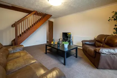 a living room with a couch and a table at 52 Carr Avenue in Leiston
