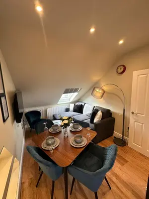 a living room with a table and a couch at Central Cambridge Apartments by Tas in Cambridge