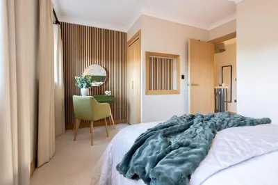 a bedroom with a bed and a chair and a table at Luxury Stay, City Walk, Pool Table & Air Hockey, Garden, Parking, Business & Families - Oakview in Colchester