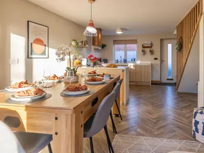 a dining room and kitchen with a table and chairs at Luxury Stay, City Walk, Pool Table & Air Hockey, Garden, Parking, Business & Families - Oakview in Colchester
