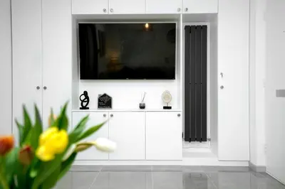 a living room with a tv on a white cabinet at Lucas in Sudbury