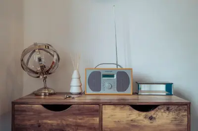 a radio sitting on top of a wooden dresser at 2 Bedroom Peaceful Home, Colchester in Mile End