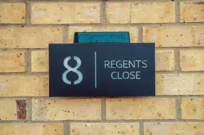 a sign on a brick wall that reads urgent close at 2 Bedroom Peaceful Home, Colchester in Mile End