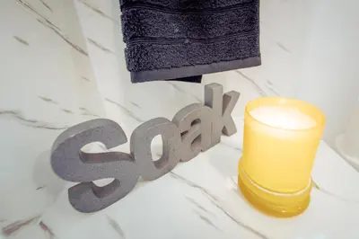 a candle and the word spa next to a spell at 2 Bedroom Peaceful Home, Colchester in Mile End