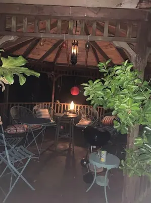 a room with chairs and a table with a candle at Barn studio in Long Melford in Long Melford
