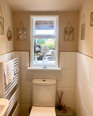 a bathroom with a white toilet and a window at Chelmsford Cottage Free Parking Fab Garden in Great Waltham