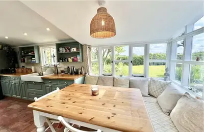 a living room with a couch and a wooden table at Chelmsford Cottage Free Parking Fab Garden in Great Waltham