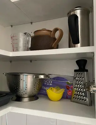 a kitchen shelf with a pot and other kitchen items at Beautiful Peaceful Studio Flat in Waltham Abbey