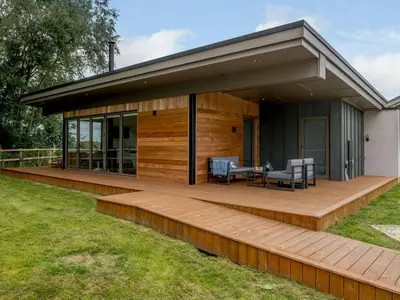 a house with a deck with a table and chairs at 2 Bed in Colchester oc-82398 in East Bergholt