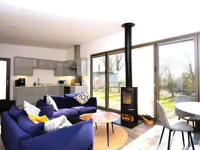 a living room with blue couches and a table at 2 Bed in Colchester oc-82398 in East Bergholt