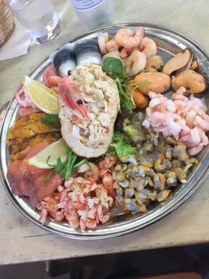 a plate of food with seafood on a table at Lazeeedays on Mersea Island in Colchester