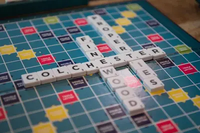 a close up of a monopoly board with the word addicted at Fun house in the heart of Colchester in Colchester