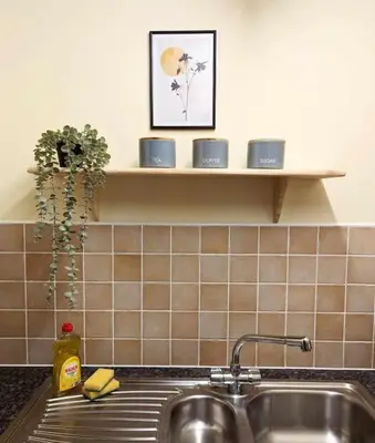 a kitchen counter with a sink and a shelf at 3-Bed, Sleeps 6, 1 Bath, Parking, WiFi in Bramford