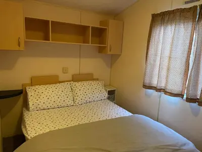 a small bedroom with a bed and a window at BelLa VistA - Holiday Home On The Beach in Clacton-on-Sea