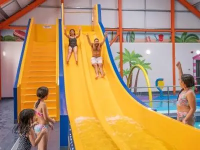 a group of children playing on a slide in a pool at BelLa VistA - Holiday Home On The Beach in Clacton-on-Sea