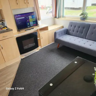 a living room with a couch and a tv at BelLa VistA - Holiday Home On The Beach in Clacton-on-Sea
