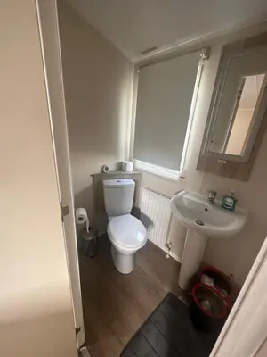 a small bathroom with a toilet and a sink at 4 Bed 10 Berth Caravan Seawick Holiday Park in Saint Osyth