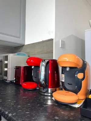 a kitchen counter with various appliances on a counter top at 12 Penn Gardens- Apart 2 in Friern Barnet