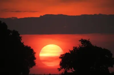 a sunset with the sun in the sky at Newmans Lodge in Lavenham
