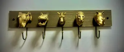 a row of gold masks hanging on a wall at 6 Bedroom House - DISC0UNTS - Parking, Contractors, Group, Family in Ipswich