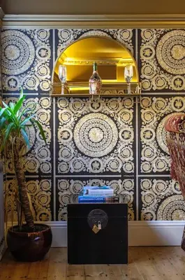 a room with a potted plant and a wall at The Famous Harry Potter House, Hot Tub, Cinema Room, Sky TV in Saffron Walden