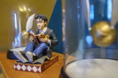 a figurine of a boy sitting on a box at The Famous Harry Potter House, Hot Tub, Cinema Room, Sky TV in Saffron Walden